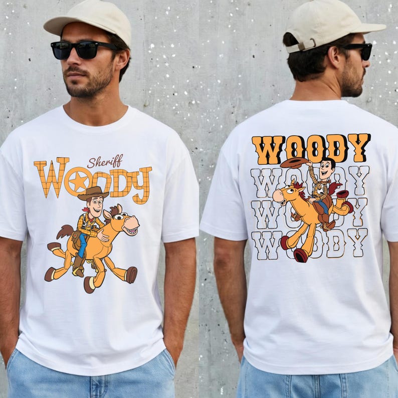 May include: White t-shirt featuring Sheriff Woody riding a horse, with the word "Woody" in a western-style font. The back of the shirt repeats "Woody" with Woody and the horse. A fun, cartoon-style design.