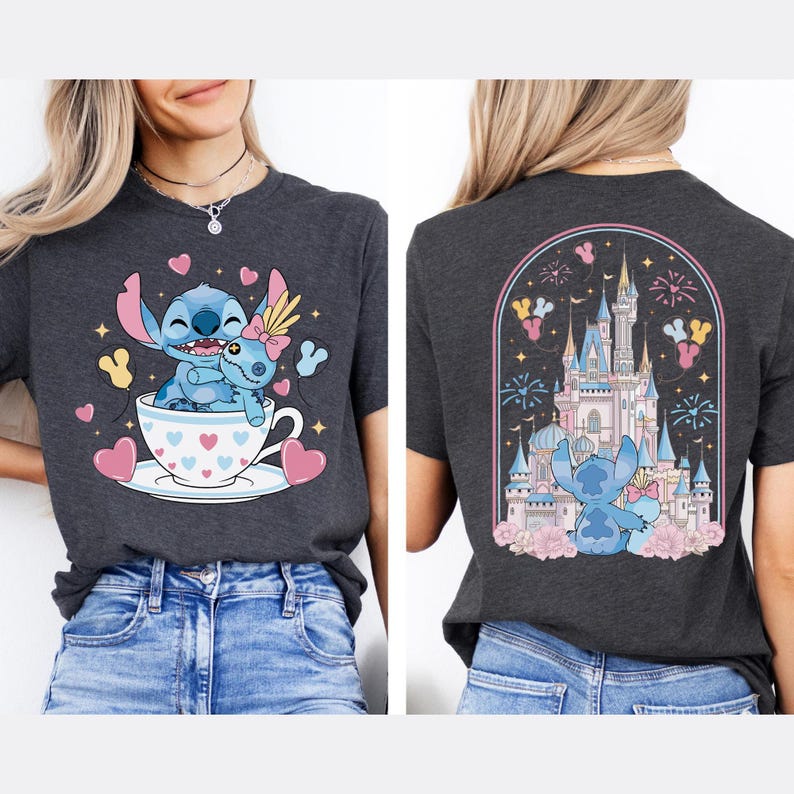 May include: Dark gray t-shirt featuring a cartoon Stitch character in a teacup with hearts and a Stitch doll. The back of the shirt shows a castle scene with Stitch. The design includes pink, blue, and yellow accents.