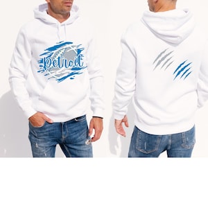 May include: White hooded sweatshirt with a blue and gray graphic of a baseball with the word "Detroit" on it. The back of the sweatshirt has a gray and blue claw mark graphic.