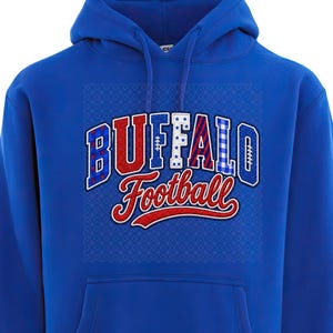 May include: A royal blue hooded sweatshirt featuring a front graphic with the text BUFFALO in a block font and Football in a script font. The letters of BUFFALO contain various patterns including stars, stripes, and plaid in red, white, and blue.