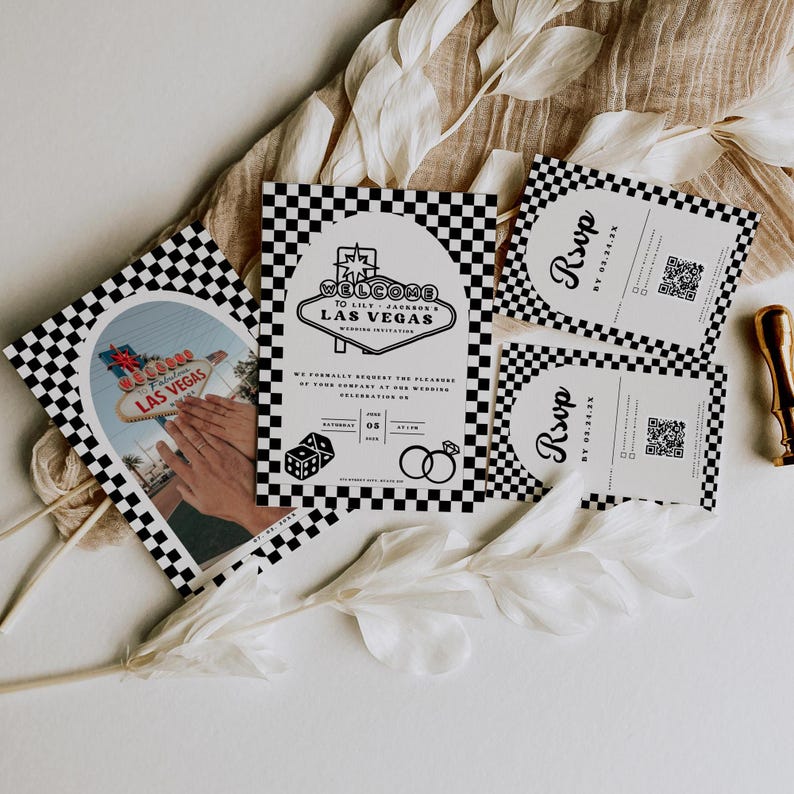 May include: Black and white checkered wedding invitation with a Las Vegas theme. The invitation features a welcome to Las Vegas sign with a red neon glow. The invitation also includes a RSVP card with a QR code.