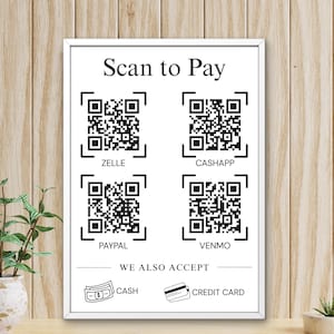 May include: A white rectangular sign with a thin frame featuring the text Scan to Pay at the top. It displays four black and white QR codes labeled Zelle, Cashapp, Paypal, and Venmo. Below, the text We Also Accept appears with icons for cash and a credit card.