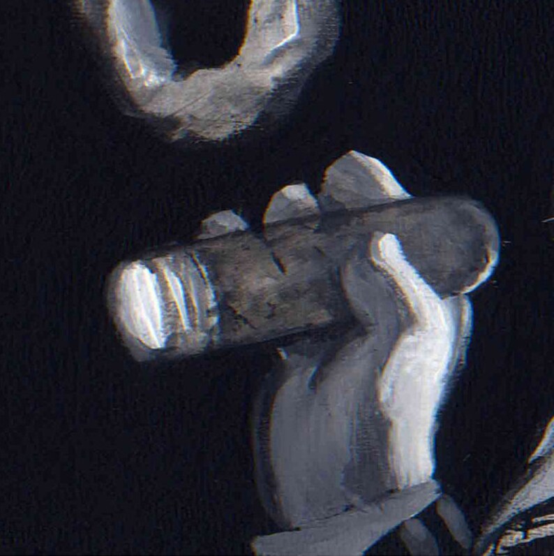 May include: A hand holding a dark brown cigar with a white band.