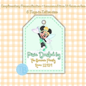 May include: A green and yellow pixie dust tag with a cartoon image of a fairy with wings. The tag says "Pixie Dusted by The Bournie Family Room: 12939".