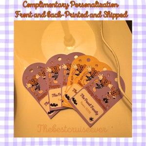 May include: Heart-shaped Halloween-themed tags in purple and orange. Each tag features a cartoon character with a pumpkin head and the text "Happy Halloween." Some tags include the text "The Pearl Family" and a room number.