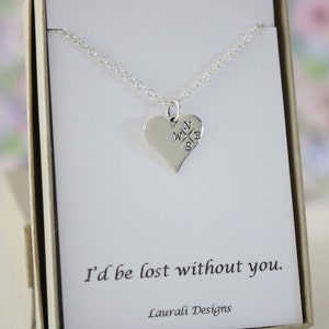 May include: Silver necklace with a heart pendant featuring a compass design. The pendant reads "N W E S" and the necklace is in a white box with the text "I'd be lost without you." and "Laurali Designs".