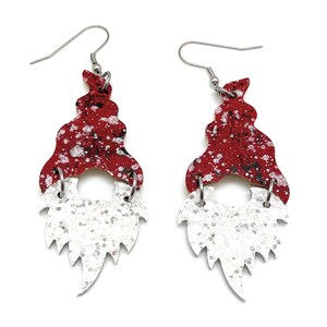 May include: Red and white glitter gnome earrings with silver hooks. The gnome hat is red with white glitter and the beard is white with silver glitter.