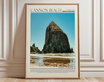 May include: Framed print featuring Cannon Beach, Oregon, USA. The image showcases a large, rocky sea stack against a clear blue sky. The beach and ocean are visible in the foreground, with the text "Cannon Beach" at the top.