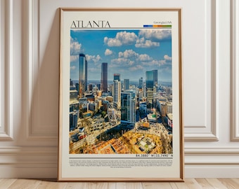 May include: A framed print depicting the Atlanta skyline, Georgia, with tall buildings against a blue sky and clouds. The print includes the city name, state, and coordinates. The frame is a neutral colour.