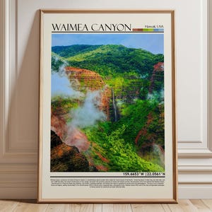 May include: Framed print of Waimea Canyon, Hawaii, USA. The landscape features a waterfall cascading down a lush, green, and red-hued canyon. The print includes the text "Waimea Canyon" and coordinates 159.6653°W 22.0561°N.