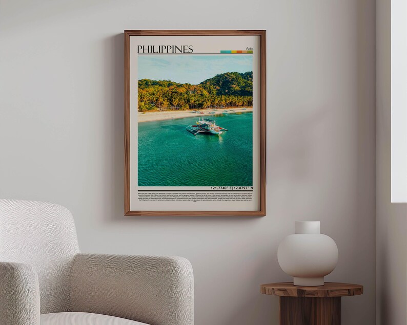 May include: A framed print of the Philippines, showcasing a tropical beach scene with turquoise water, white sand, and lush green hills. The print includes the word "PHILIPPINES" at the top and coordinates at the bottom. The frame is a warm brown.