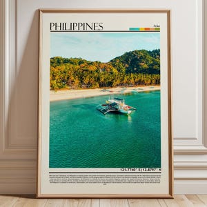 May include: Framed print featuring a vibrant tropical scene of the Philippines. The image showcases a turquoise ocean, a white sandy beach, and lush green hills. A boat floats in the water. The word "PHILIPPINES" is at the top.