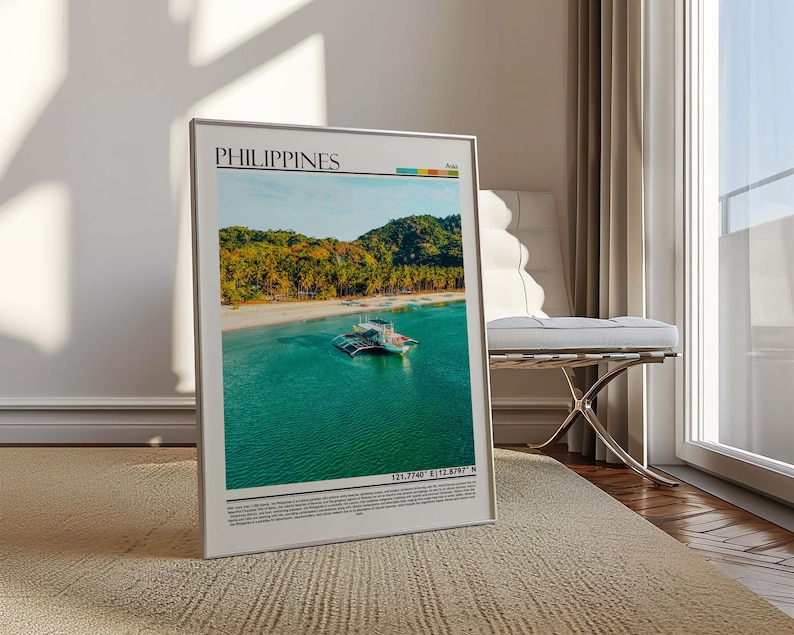 May include: A framed print featuring a tropical beach scene in the Philippines. The image shows a boat in turquoise water, a sandy beach, and lush green hills under a blue sky. The word "PHILIPPINES" is at the top.