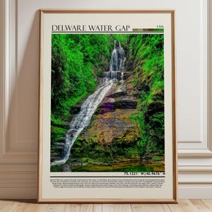 May include: Framed print featuring a scenic view of the Delaware Water Gap in the USA. The image showcases a cascading waterfall surrounded by lush green foliage and rocky terrain. The print includes the text "DELAWARE WATER GAP" and coordinates.
