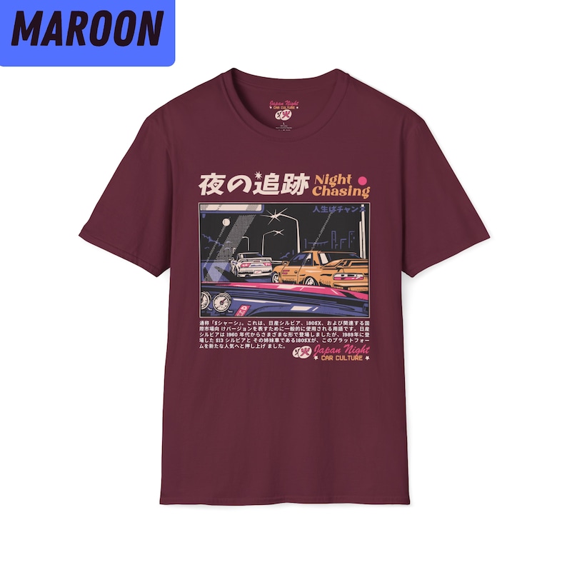 May include: Maroon t-shirt with a graphic print of two cars driving at night. The text "Night Chasing" is printed in white with a red circle. The Japanese text "夜の追跡" is printed in white with a pink circle. The text "人生はチャンス" is printed in white. The text "Japan Night Car Culture" is printed in white.
