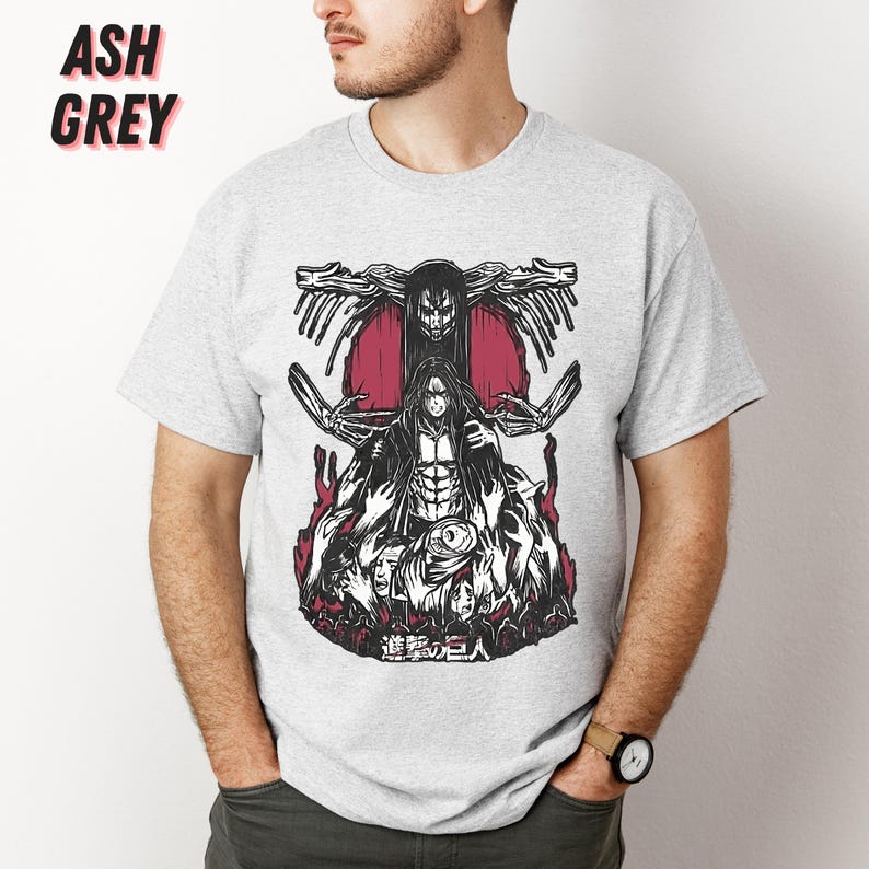 May include: A grey t-shirt with a black and white graphic print of a character from the anime Attack on Titan. The character is surrounded by other characters and the text "進撃の巨人" is printed below the graphic.