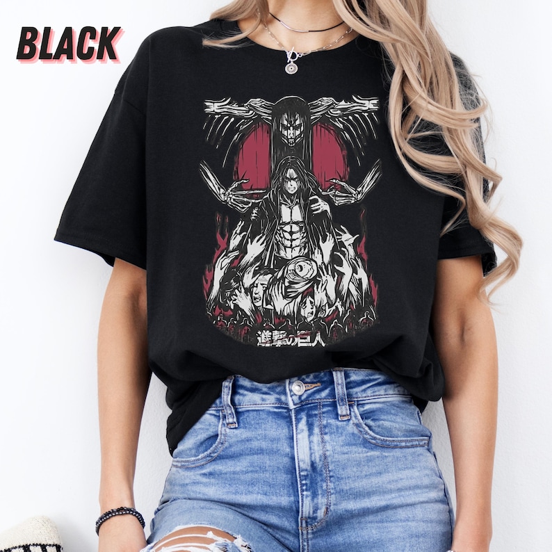 May include: Black t-shirt with a graphic print of a character from the anime Attack on Titan. The character is standing in front of a red background with flames and the text "進撃の巨人" in Japanese.