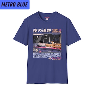 May include: A blue t-shirt with a graphic of two cars driving at night. The graphic includes Japanese text that reads "Night Chasing" and "Japan Night Car Culture".