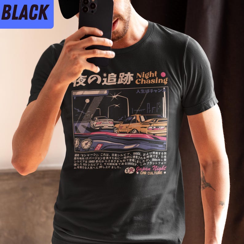 May include: Black t-shirt with a graphic print of two cars driving at night. The text on the shirt reads "Night Chasing" and "Japan Night Car Culture".