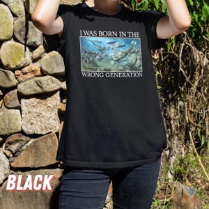 May include: Black t-shirt featuring a graphic of prehistoric sea creatures and the text "I was born in the wrong generation."