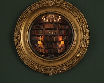 May include: A round convex mirror featuring an ornate, textured gold-toned frame with intricate scrollwork details. The reflective surface displays a wide-angle, distorted view of a library interior with bookshelves, lamps, and a chandelier.