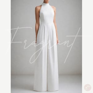 May include: A white halter jumpsuit with a high neck and wide legs. The jumpsuit is made of a smooth, flowing fabric.