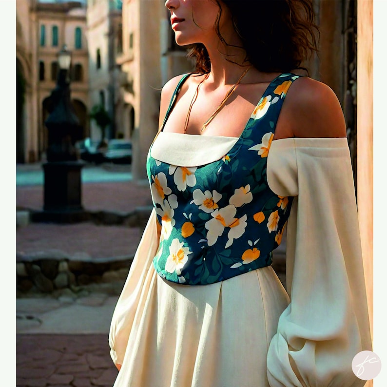 Puede incluir: Una mujer lleva un vestido blanco con un corpi&ntilde;o de estampado floral. El corpi&ntilde;o tiene un escote cuadrado y es sin mangas. El vestido tiene una falda completa y est&aacute; ajustado a la cintura. La mujer est&aacute; de pie frente a un edificio con una fachada de piedra.