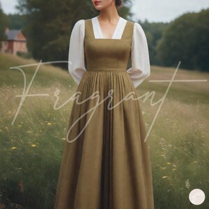 May include: An olive green dress with a square neckline and a white bodice. The dress has long, puffy white sleeves and a full skirt. The word "Fragrant" is written across the front of the dress in a cursive font. The dress is worn in a field.