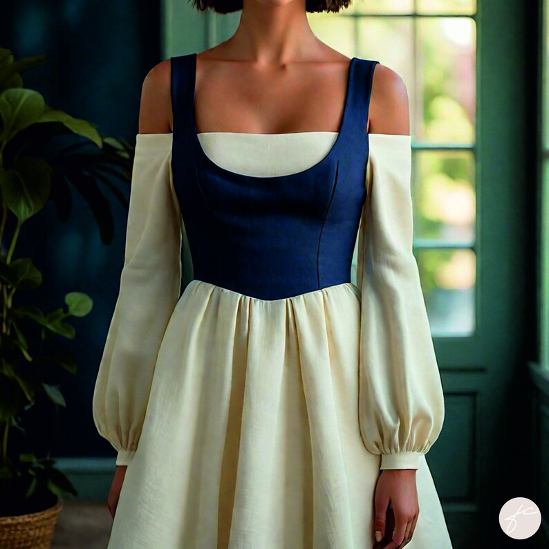 Puede incluir: Un vestido blanco con un corpi&ntilde;o azul y tirantes de hombros descubiertos. El vestido tiene mangas largas con pu&ntilde;os abullonados y una falda fruncida.