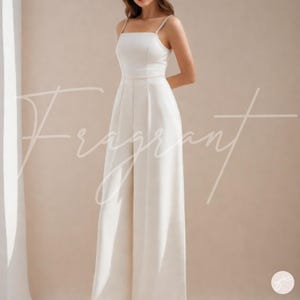 May include: A white sleeveless jumpsuit with a square neckline and wide legs. The jumpsuit has a fitted bodice and a flowy skirt.