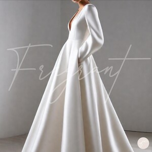 May include: A white satin wedding dress with a deep V-neckline and long sleeves. The dress has a fitted bodice and a flowing skirt.