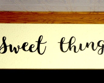 Laser cut wooden sign in three words. "Sweet things happen"