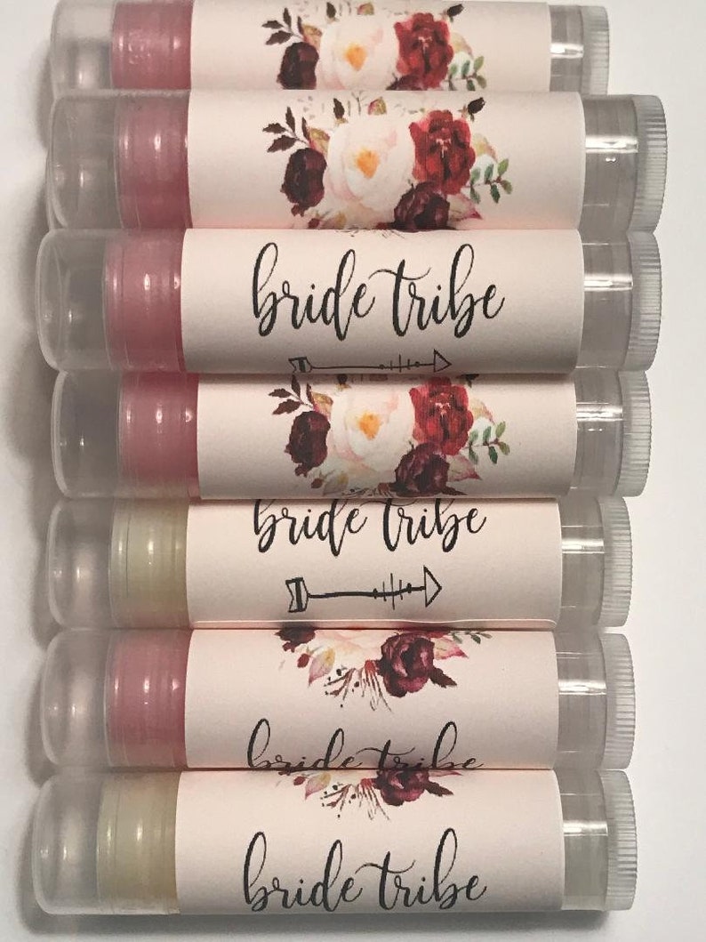 May include: A stack of eight clear tubes with pink and white labels. The labels feature a floral design with burgundy and pink flowers and the text "bride tribe".
