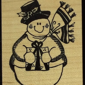 May include: A black and white illustration of a snowman wearing a hat and scarf, holding a gift box with a bow.