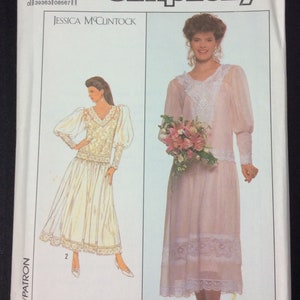 May include: Simplicity sewing pattern number 9052, size 16, for a bridal gown with lace details. The pattern includes two different styles, one with a long skirt and the other with a shorter skirt. The model is wearing a white gown with a lace bodice and a long skirt, and a pink gown with a lace bodice and a shorter skirt.