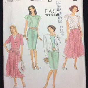 May include: Simplicity sewing pattern #104 for sizes 6-14. The pattern includes instructions for making three different dresses: a green dress with a belt, a pink polka dot dress with a skirt, and a green dress with a jacket. The pattern is labeled "Easy to Sew".