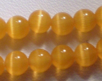 4mm Soft Orange Round Cat's Eye Glass Bead 8 Inch Strand