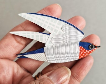Pacific Swallow - handmade pin badge brooch. Paper collage on laser cut plywood ply.