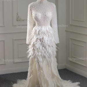 Luxury Wedding Dresses. Pearl and Feather Wedding Dresses. Trumpet Wedding Dresses with Thigh Slits and Pearls and Feathers. Custom Dress