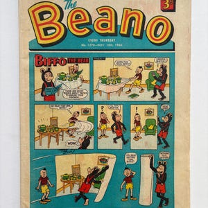 May include: A vintage The Beano comic book from 19th November 1966, featuring a colourful cover illustration of Biffo the Bear in a multi-panel comic strip. The cover displays the title in large yellow letters with red outlines and a price of 3d.