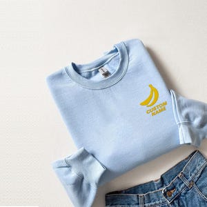 Custom Name Embroidered Negative Space Banana Hoodie And Sweatshirt, Personalized Fruit Sweater, Cozy Gift for Quirky Style Lovers