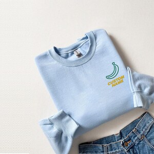Custom Name Embroidered OneLine Outline Banana Hoodie And Sweatshirt, Personalized Fruit Apparel, Cozy Gift for Banana Lovers