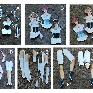 May include: A set of paper doll cutouts featuring a woman in various outfits. The set includes a black and white striped dress, a white dress with a black corset, a white dress with a blue corset, a white dress with a pink corset, and a white dress with a black corset. The set also includes a pair of black stockings, a pair of white stockings, a pair of black shoes, a pair of white shoes, and a pair of arms.