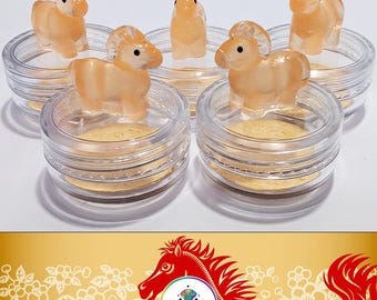 May include: The image features several small, translucent orange horse figurines displayed in clear, round containers. The text "LILYPADS - YEAR OF THE HORSE" is at the top. Below, a red horse illustration with the text "2026 YEAR OF THE HORSE" is shown.