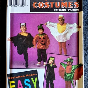May include: A Simplicity sewing pattern for children's Halloween costumes. The pattern includes five costumes: a bat, a pumpkin, a ghost, a vampire, and a dragon. The pattern is labelled "Costumes Made Easy".