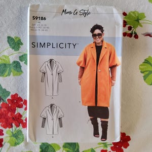 May include: A Simplicity sewing pattern for a coat with puff sleeves. The pattern number is S9186 and the size is H5. The pattern includes instructions for sizes 6-14, 32-40, and 34-42.
