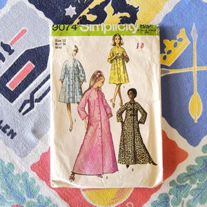 May include: Vintage Simplicity sewing pattern, size 12, featuring illustrations of women's coats and dresses. The pattern envelope displays the number 9074 and includes the bust size 34. The background is a colorful floral and geometric patterned fabric.