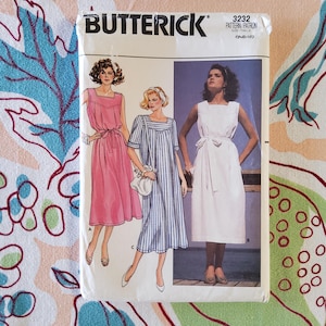 May include: A Butterick sewing pattern packet featuring illustrations of three different dresses. The dresses are in pink, white, and blue and white striped fabric. The packet has the number 3232 and the Butterick logo at the top.