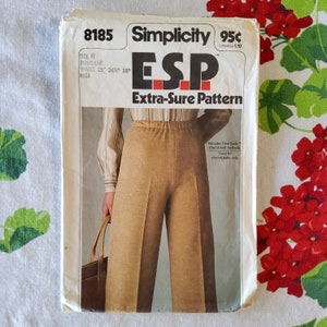 May include: A vintage Simplicity sewing pattern for pants, labeled "ESP Extra-Sure Pattern." The pattern is for sizes 25, 26, and 28 inches and is designed for stretch knit fabrics.