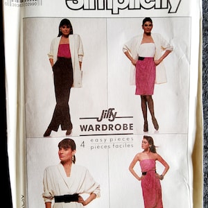 May include: A vintage Simplicity sewing pattern, size 14, featuring a "Jiffy Wardrobe" with four easy pieces. The pattern includes images of a jacket, skirt, and pants ensemble. The pattern's text includes "Overlock/Serger" instructions.